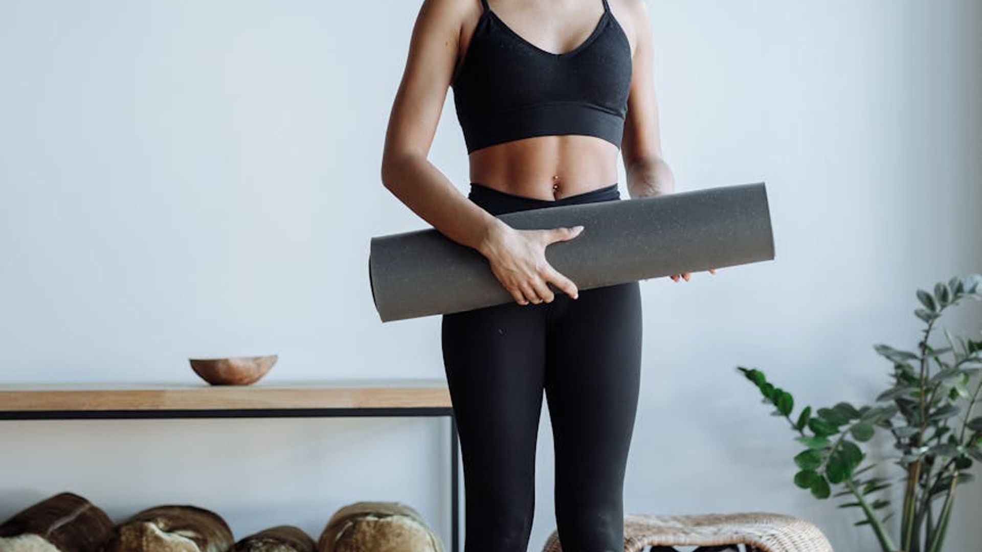 Person practicing yoga in a bright minimalistic studio space